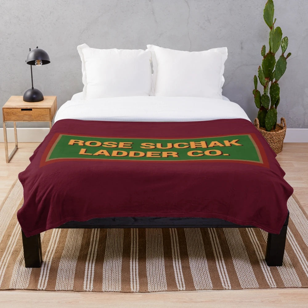 Retro Santa Clause inspired plush blanket with rose suchak ladder company logo