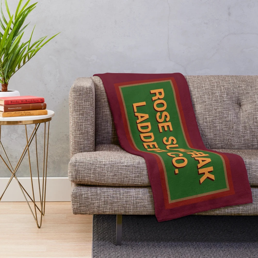 Retro Santa Clause inspired plush blanket with rose suchak ladder company logo