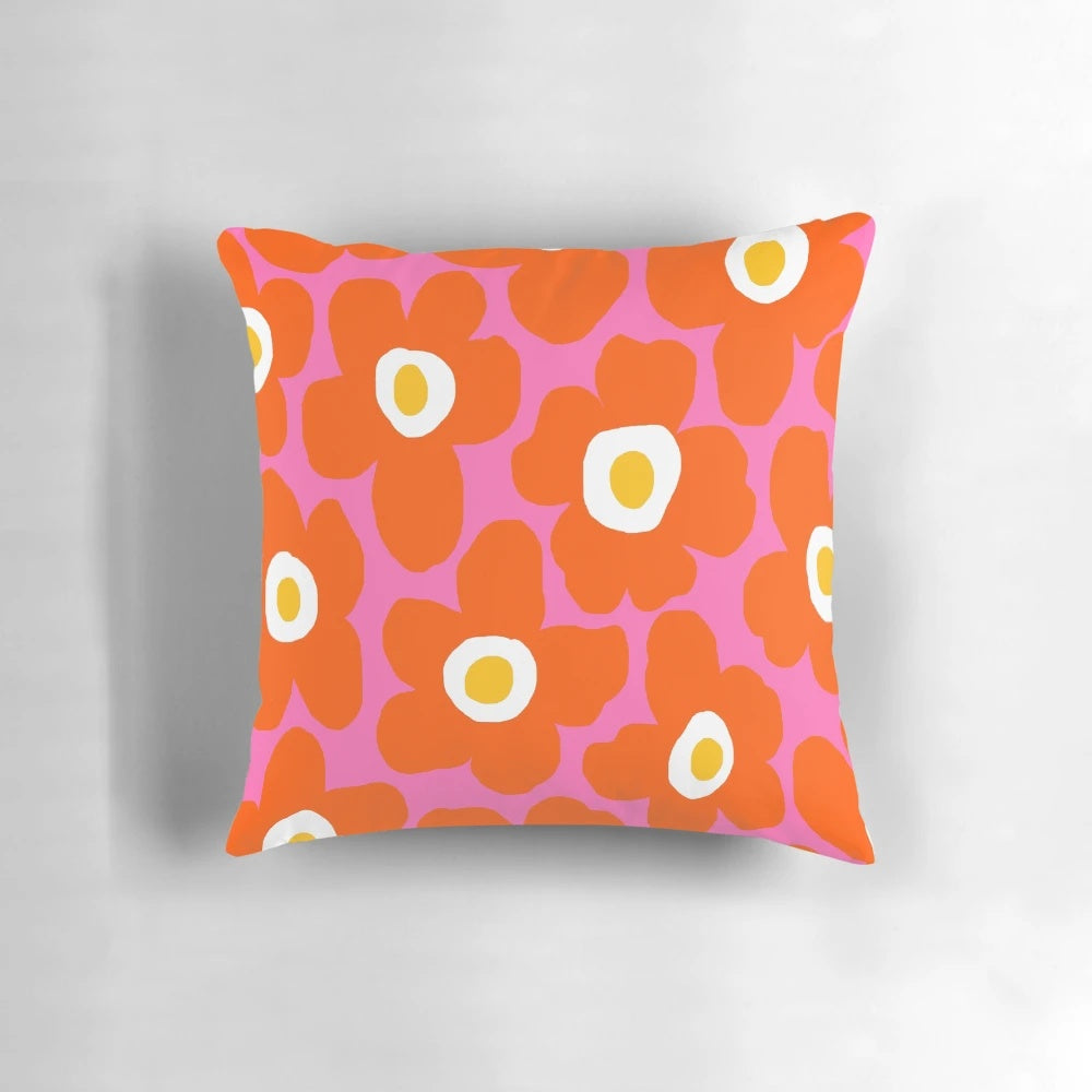 Retro Scandinavian-inspired floral pattern pillow in vibrant pink and orange colors