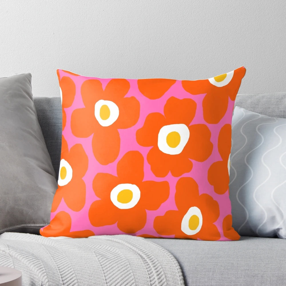 Retro Scandinavian-inspired floral pattern pillow in vibrant pink and orange colors