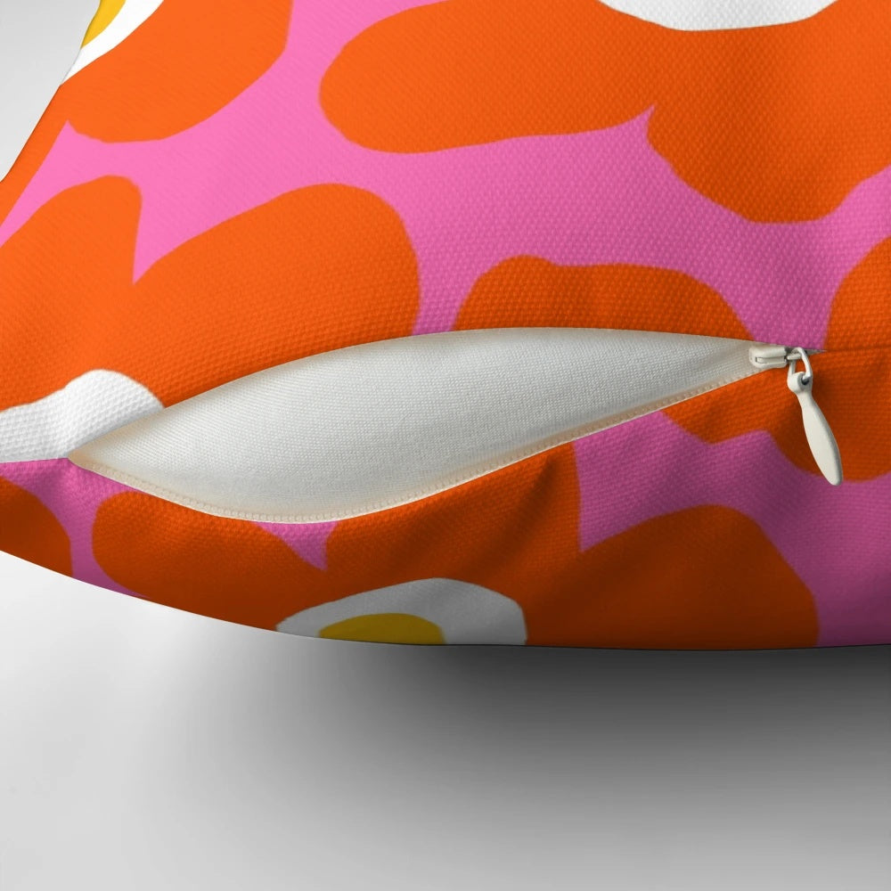 Retro Scandinavian-inspired floral pattern pillow in vibrant pink and orange colors
