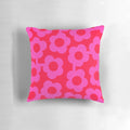 Vibrant Scandinavian-inspired floral pillow in shades of pink and neon red
