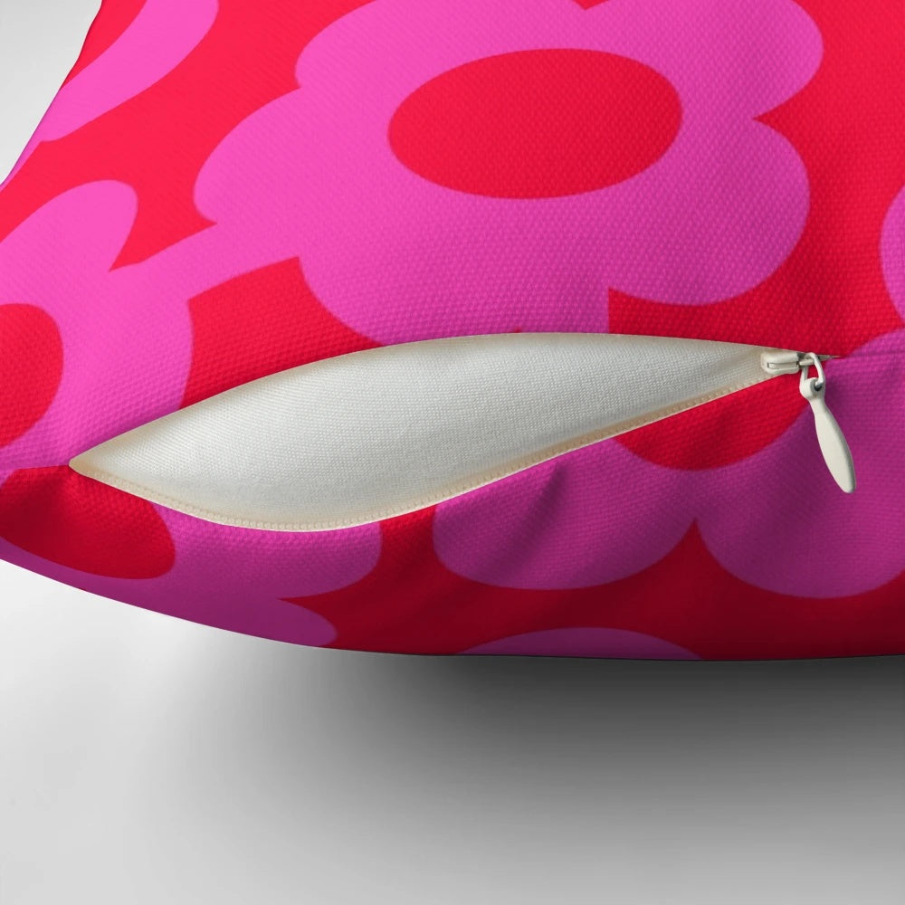 Vibrant Scandinavian-inspired floral pillow in shades of pink and neon red