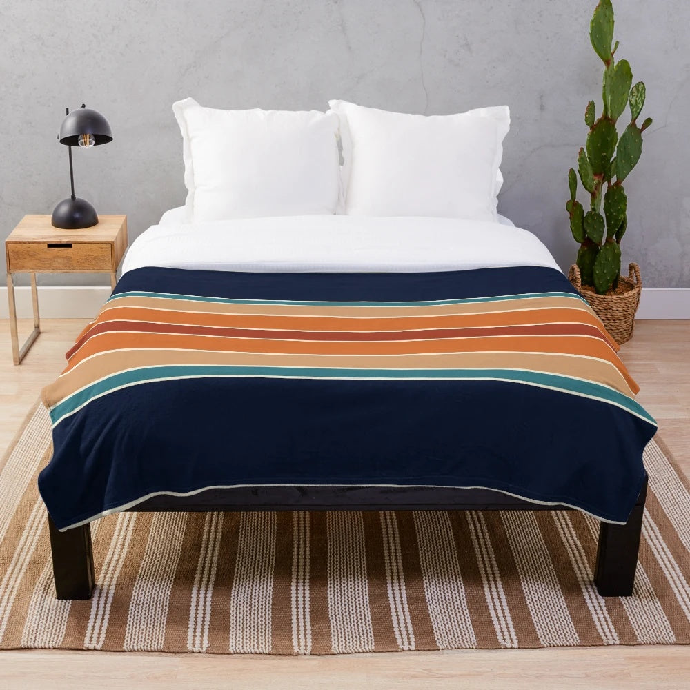 Retro striped plush blanket in mid century modern colors of rust, blue, and teal