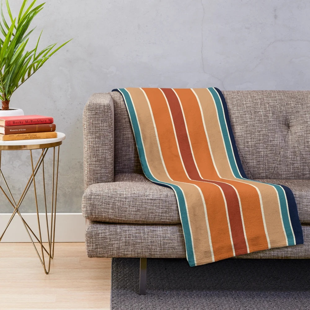 Retro striped plush blanket in mid century modern colors of rust, blue, and teal