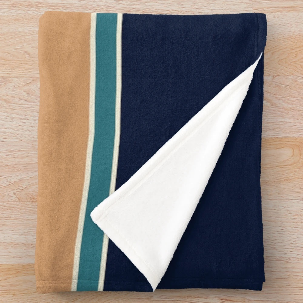 Retro striped plush blanket in mid century modern colors of rust, blue, and teal
