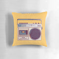 Vibrant yellow pillow with a retro-style boombox graphic, perfect for adding a touch of 80s nostalgia to any room.