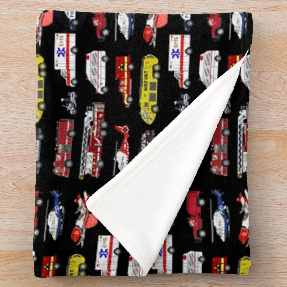 Retro-style plush blanket featuring emergency vehicles and video game-inspired design