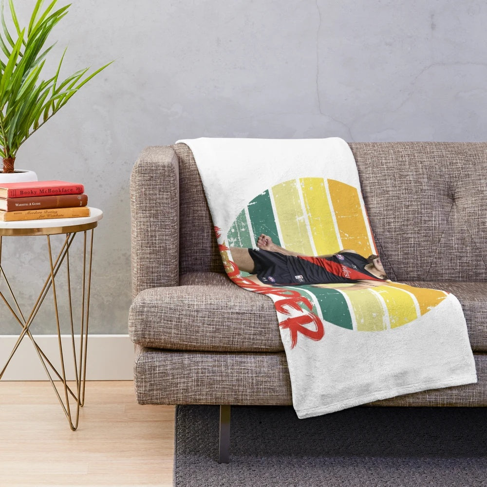 A soft, plush blanket featuring a vintage sun motif design
