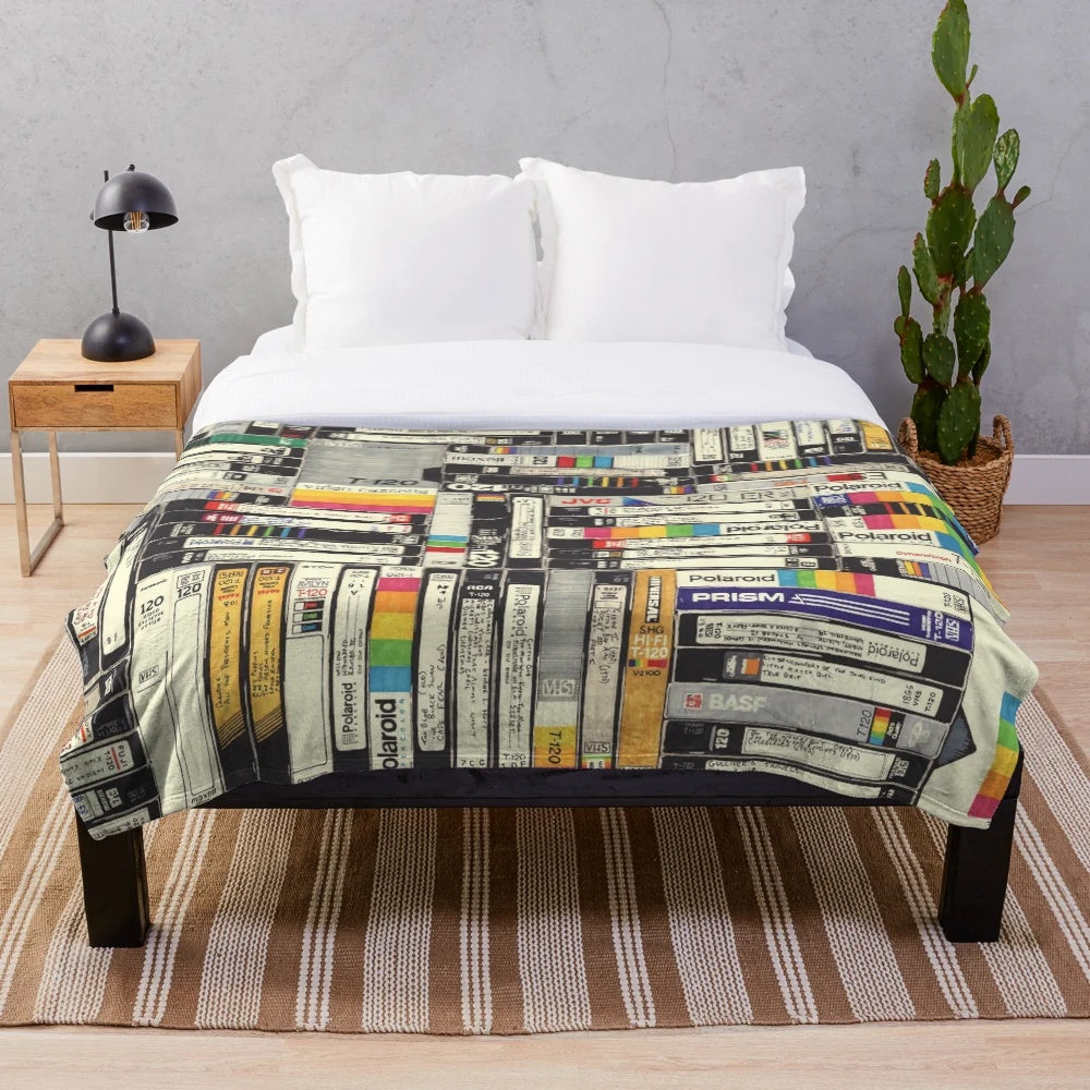 Retro VHS-inspired plush blanket with bold graphic patterns and typography