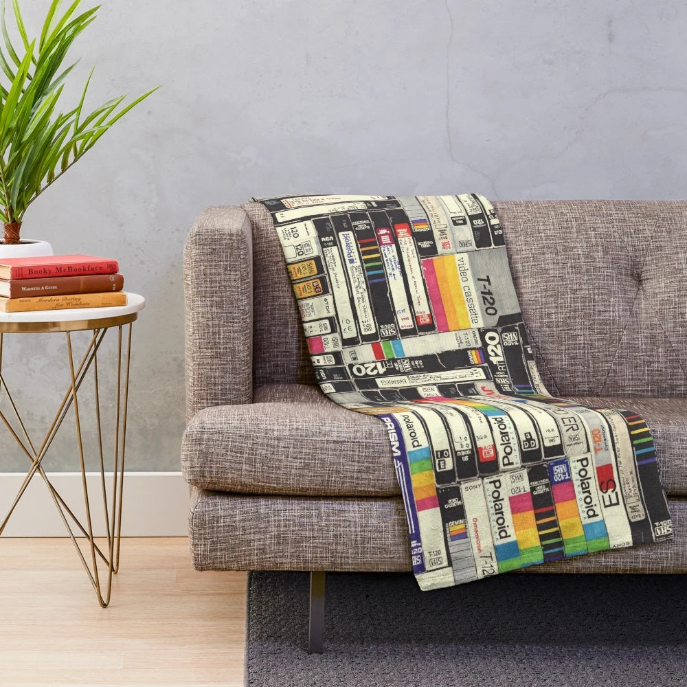 Retro VHS-inspired plush blanket with bold graphic patterns and typography