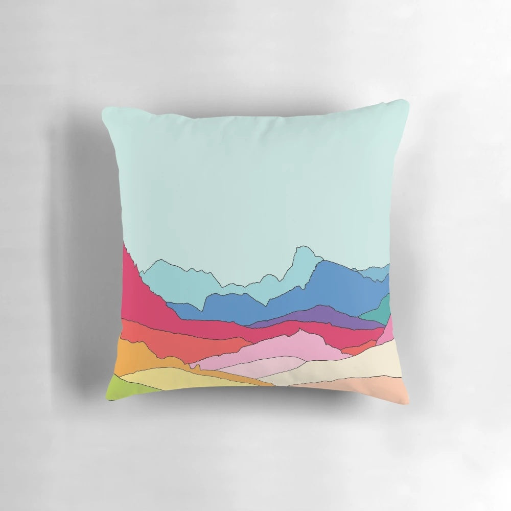Retro-inspired pillow featuring vibrant rainbow mountains design