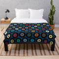 Blue plush blanket with retro vinyl record-inspired polka dot pattern and multicolor graphic design
