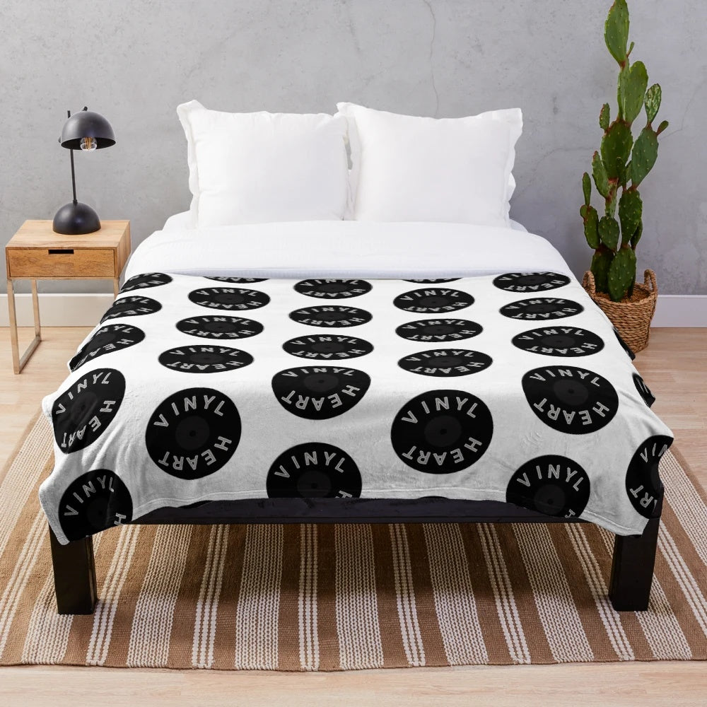 Cozy plush blanket with a vinyl record design for music lovers