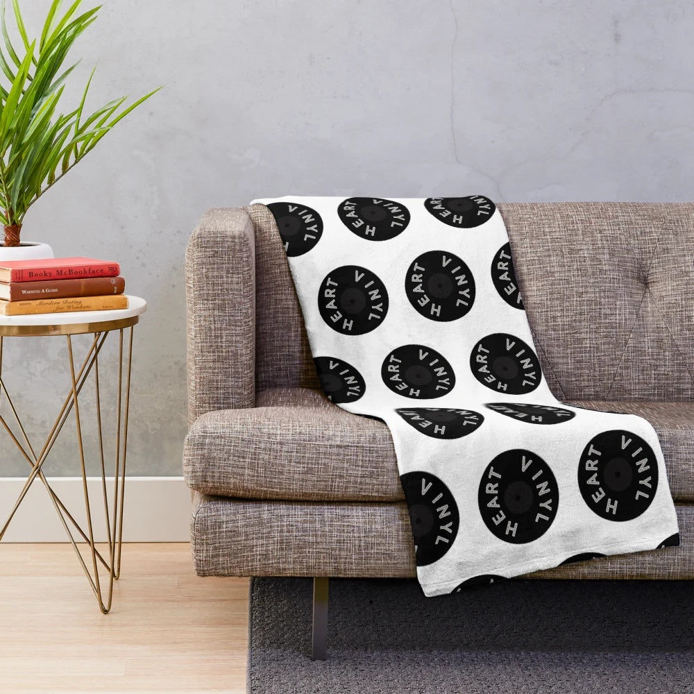 Cozy plush blanket with a vinyl record design for music lovers