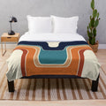 Retro wave plush blanket with geometric pattern in blue, orange, red, black, and cream colors