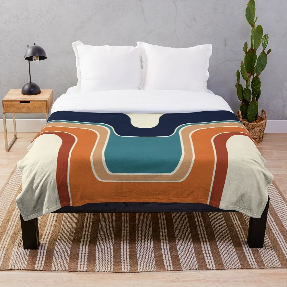 Retro wave plush blanket with geometric pattern in blue, orange, red, black, and cream colors