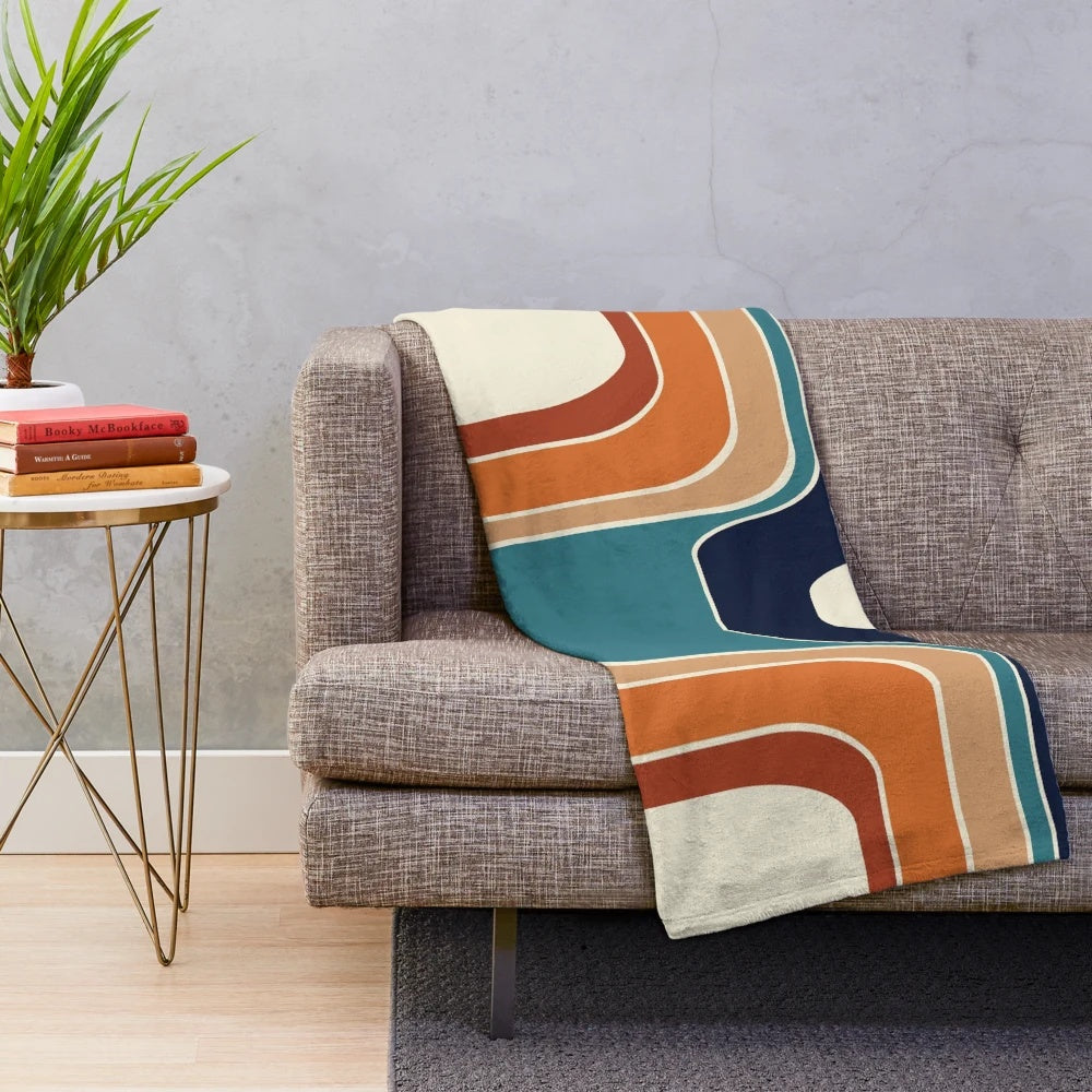 Retro wave plush blanket with geometric pattern in blue, orange, red, black, and cream colors