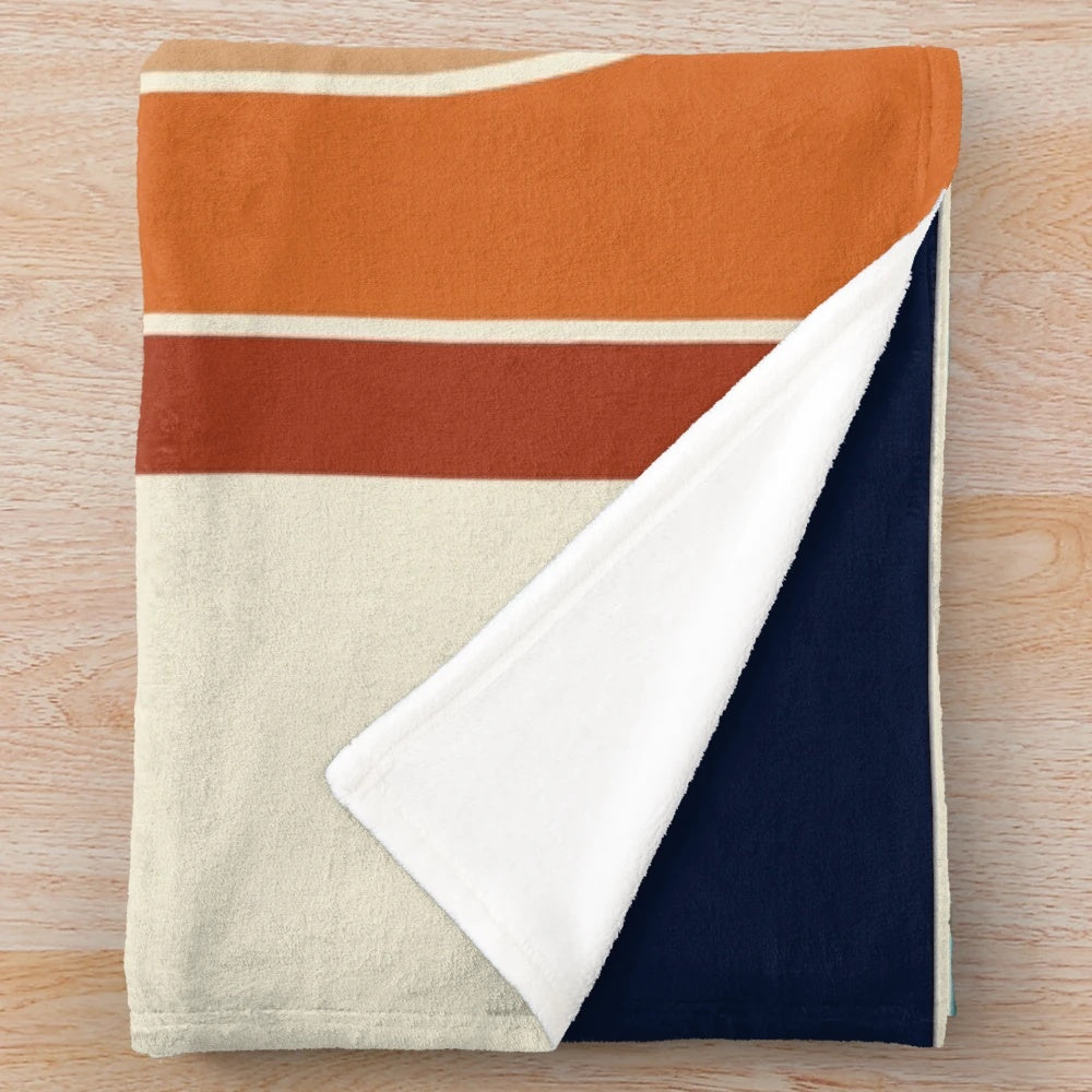 Retro wave plush blanket with geometric pattern in blue, orange, red, black, and cream colors