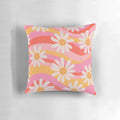 Vibrant retro floral print with wavy daisies and a cheerful, psychedelic design on a throw pillow for modern, bohemian home decor.