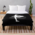 Rhythmic gymnastics penche pose silhouette on white plush blanket