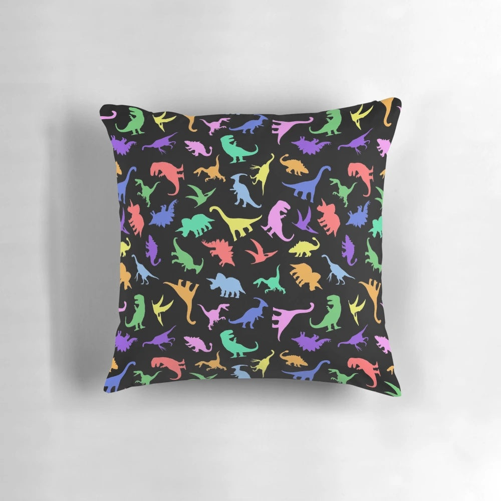 A black and white dinosaur-patterned pillow featuring various prehistoric creatures like T-Rex and Pterodactyl.