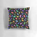 A black and white dinosaur-patterned pillow featuring various prehistoric creatures like T-Rex and Pterodactyl.