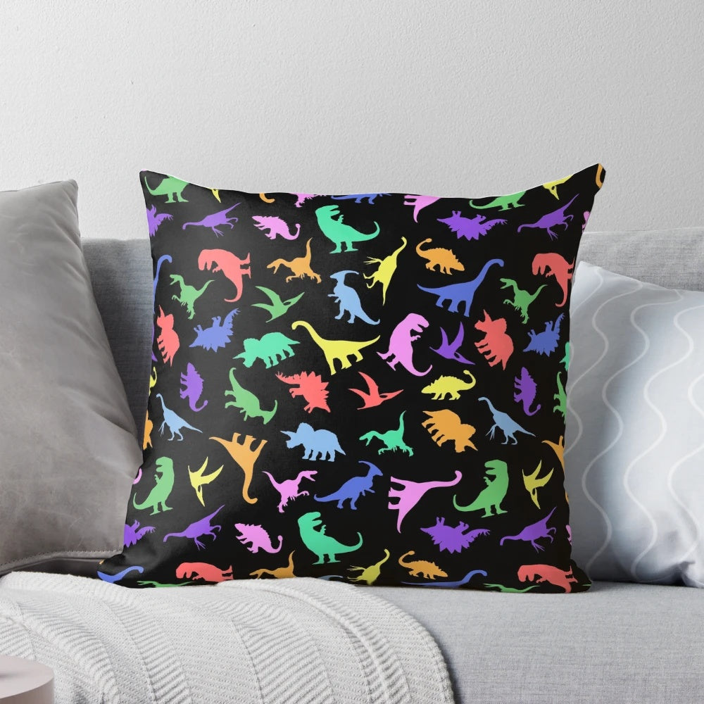 A black and white dinosaur-patterned pillow featuring various prehistoric creatures like T-Rex and Pterodactyl.