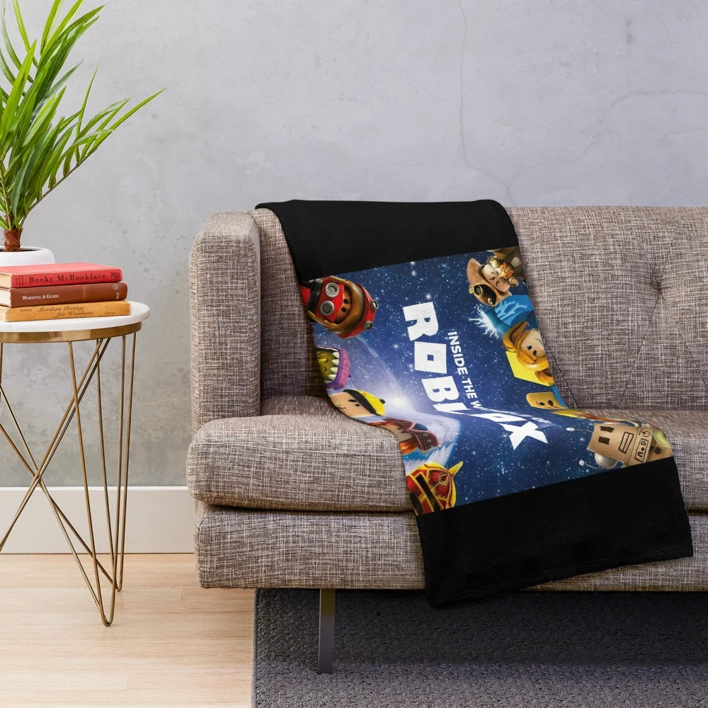 A soft and plush blanket featuring the Roblox logo and game elements