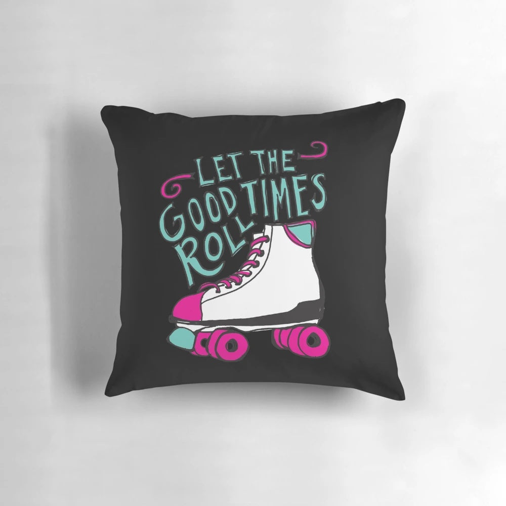 A decorative pillow featuring the phrase "Let the Good Times Roll" in a hand-lettered style, with roller skate illustrations.