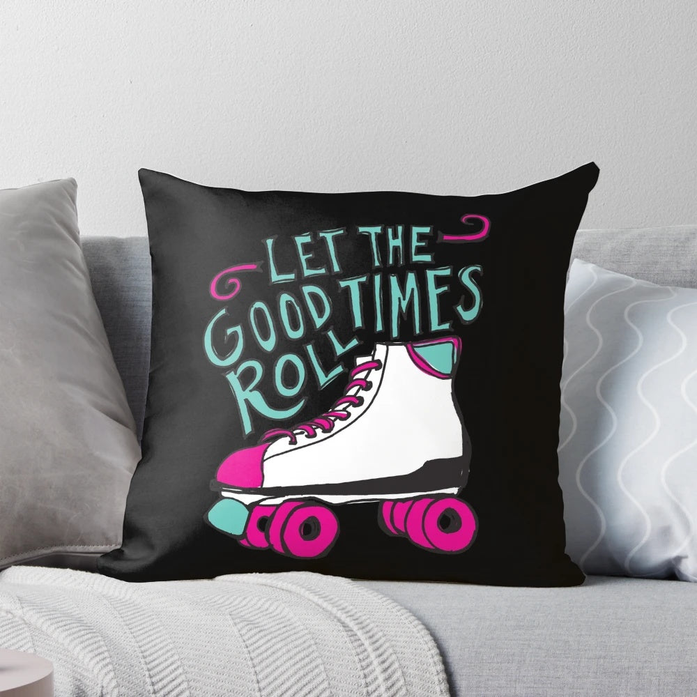 A decorative pillow featuring the phrase "Let the Good Times Roll" in a hand-lettered style, with roller skate illustrations.