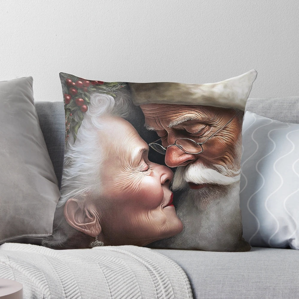 Mr. and Mrs. Santa Claus Christmas pillow with the couple kissing under mistletoe