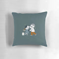 A decorative pillow featuring a dancing couple from the popular Catana Comics series.