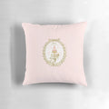 A vintage-inspired pillow featuring a French patisserie macaron label design in pastel pink and white colors.