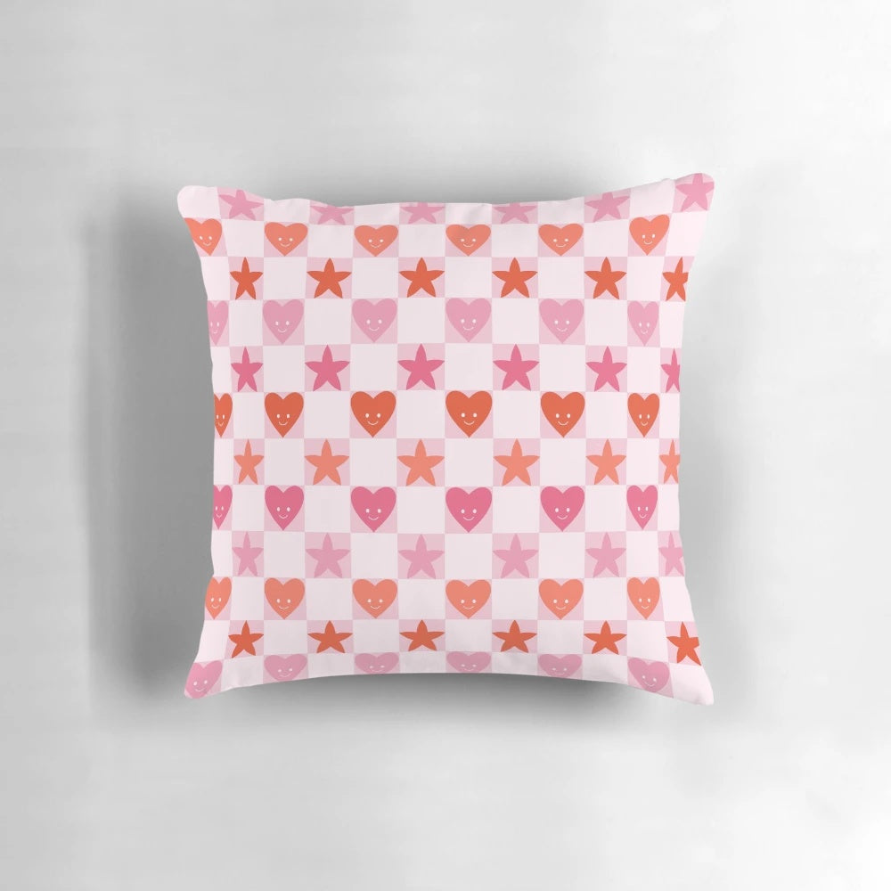 A soft, pink and red heart-shaped pillow with a checkerboard pattern, perfect for Valentine's Day, anniversaries, and cottage core home decor.