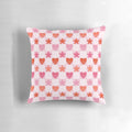 A soft, pink and red heart-shaped pillow with a checkerboard pattern, perfect for Valentine's Day, anniversaries, and cottage core home decor.