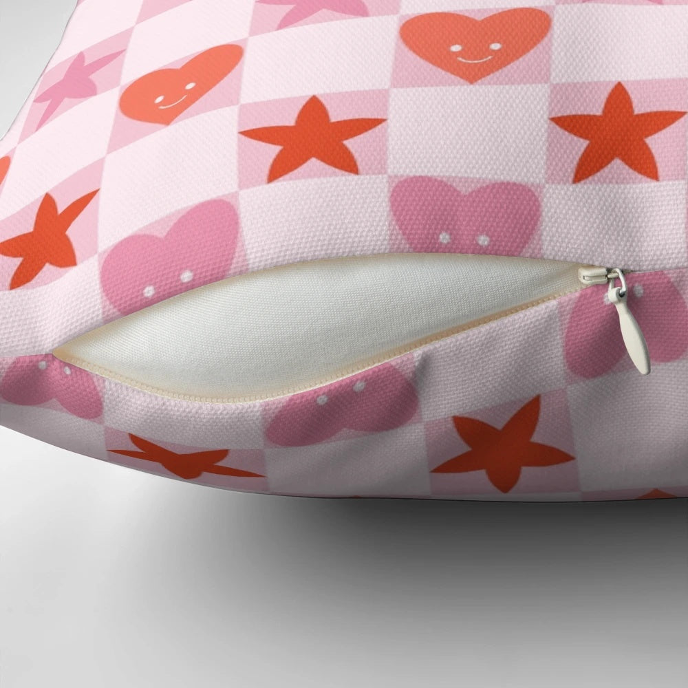 A soft, pink and red heart-shaped pillow with a checkerboard pattern, perfect for Valentine's Day, anniversaries, and cottage core home decor.