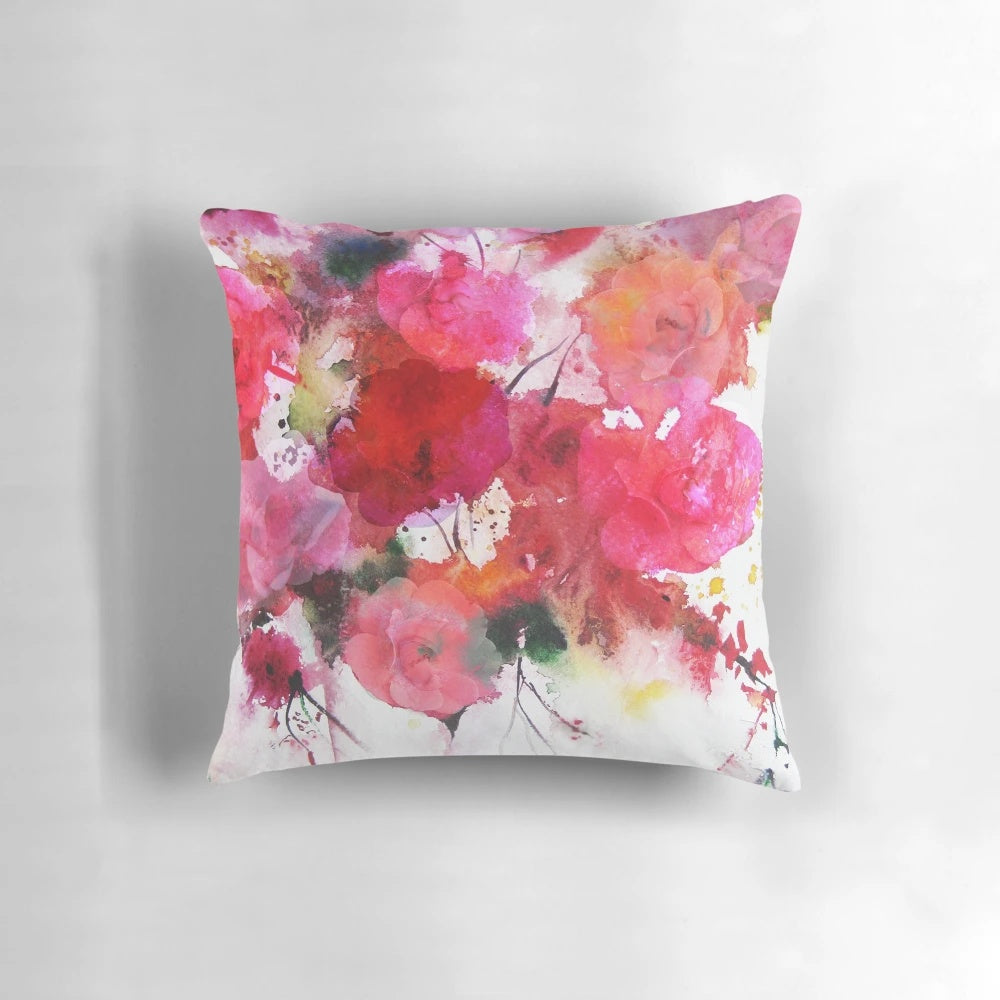 Artistic still life image of romantic pink roses in a watercolor painting style, featured on a decorative pillow.