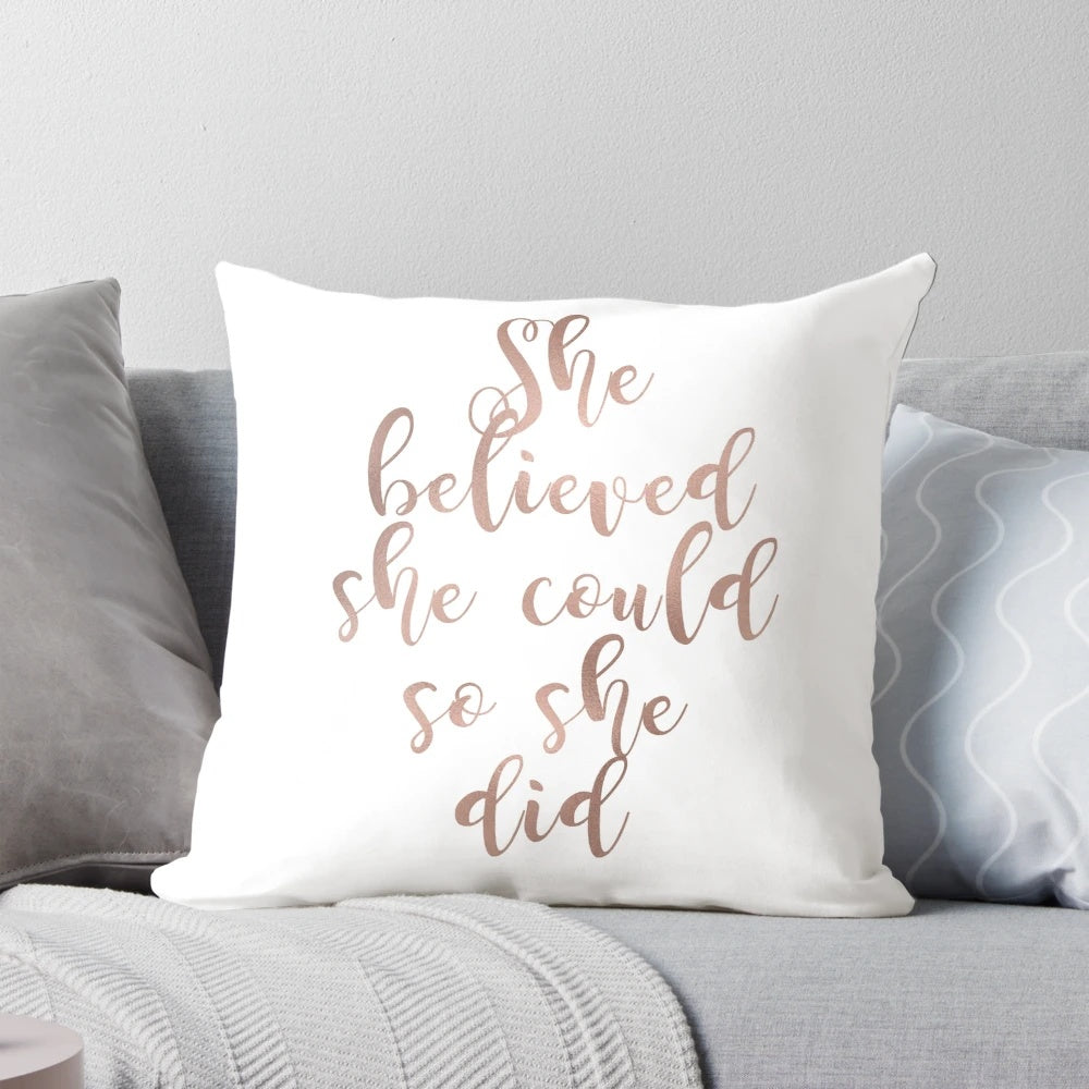 Rose gold foil-printed throw pillow with the motivational quote "She believed she could so she did"