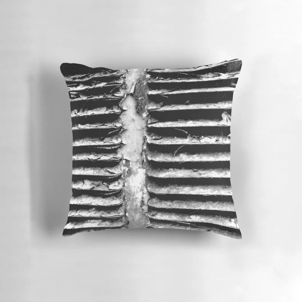 A black and white, textured pillow with a gritty, industrial design - perfect for urban-inspired home decor.