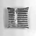 A black and white, textured pillow with a gritty, industrial design - perfect for urban-inspired home decor.