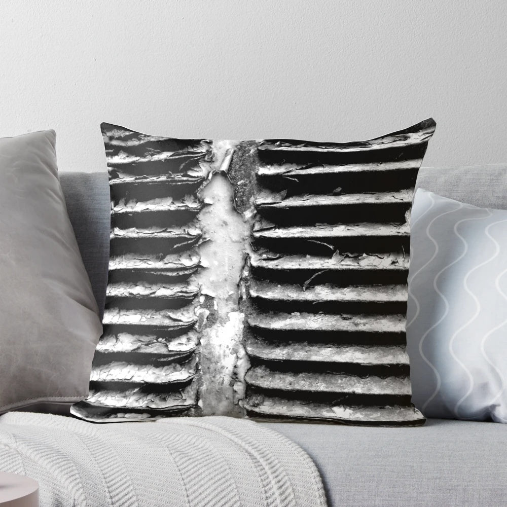 A black and white, textured pillow with a gritty, industrial design - perfect for urban-inspired home decor.