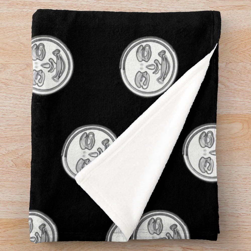 Rummikub-themed plush blanket with joker face design