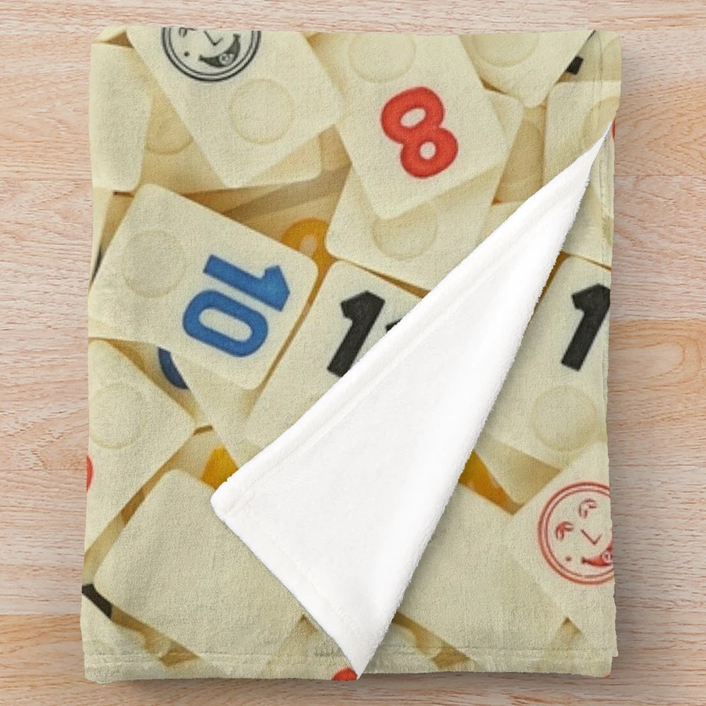 Cozy plush blanket featuring the iconic Rummikub stones pattern
