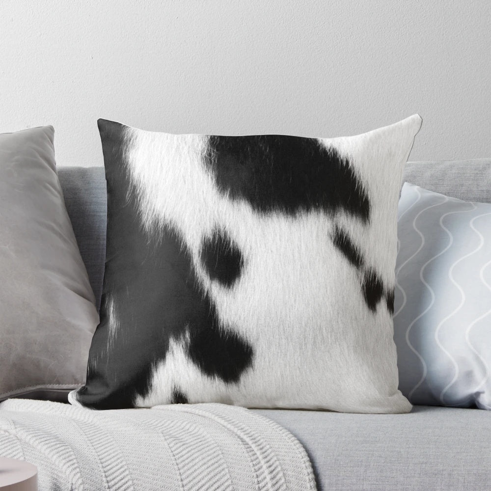 Rustic black and white cowhide pillow with natural cattle skin pattern