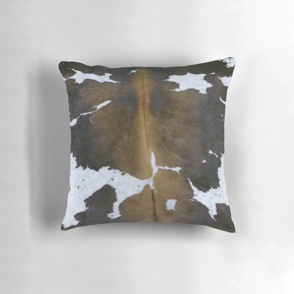 Brown cowhide pattern accent pillow with a rustic, farmhouse-inspired design