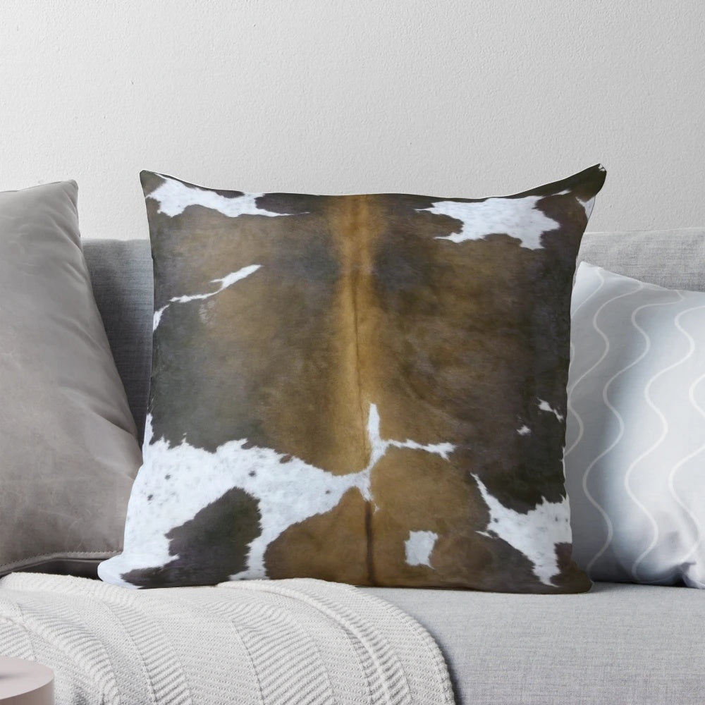 Brown cowhide pattern accent pillow with a rustic, farmhouse-inspired design