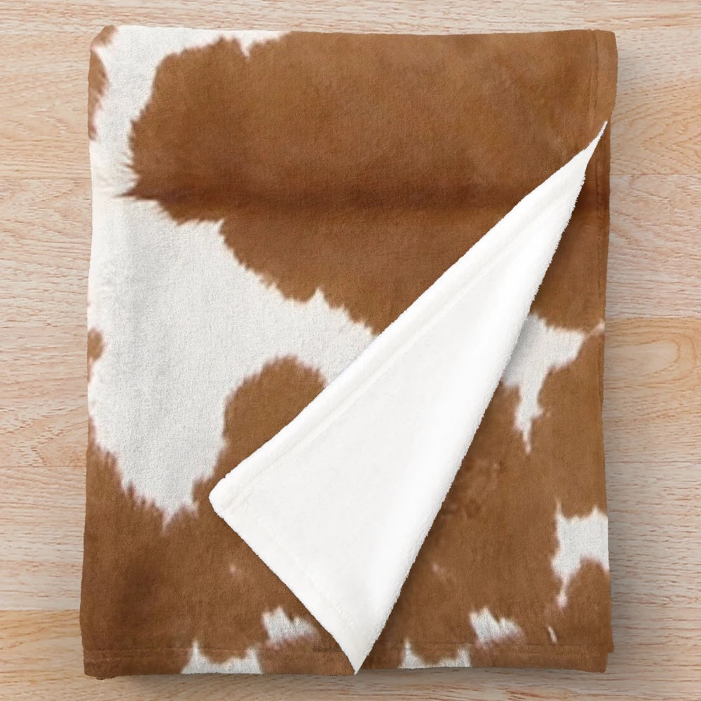 Brown cowhide plush blanket with cow print pattern