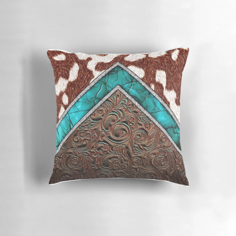 Cowhide and tooled leather pillow with a western cowgirl pattern in turquoise and brown tones