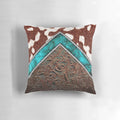 Cowhide and tooled leather pillow with a western cowgirl pattern in turquoise and brown tones